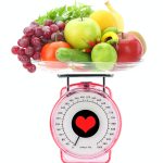 Healthy eating. Kitchen scale with fruits and vegetables