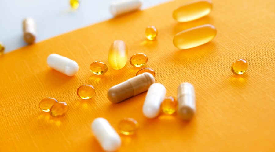 Nutraceuticals,pills and medications on yellow background