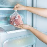 Taking frozen meat from the modern no-frost freezer